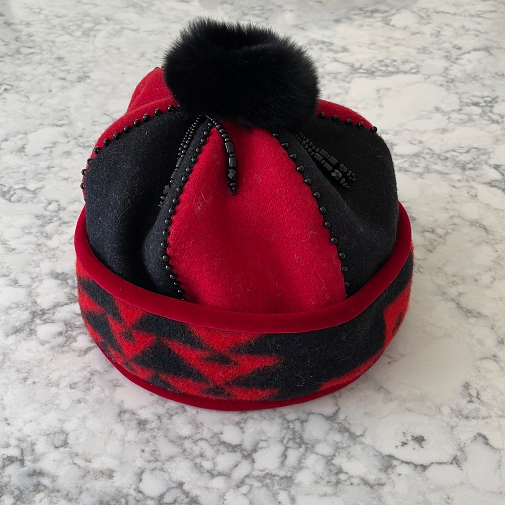 Ladies hat with fur lined interior trim and pom-pom with beading